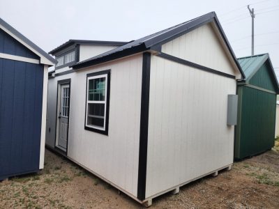 A cluster of small buildings near me, featuring 12x24 Diamond Chalet Sheds on sale.
