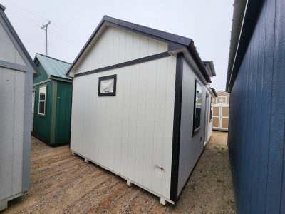 For sale shed: A 12x24 Diamond Chalet Shed with a blue roof and white siding.