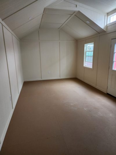 An empty 12x24 Diamond Chalet Shed with white walls and a door. Neither of the provided keywords are relevant to the given description.