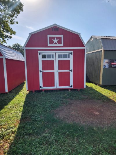 Two 10x16 Lofted Barn sheds for sale in a grassy area.