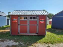 A red and blue 12x12 Utility Shed with a metal roof, available for sale nearby.
