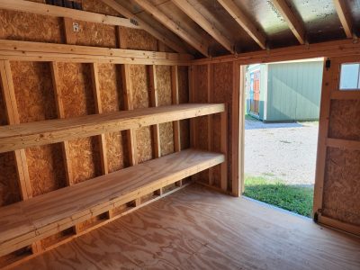 The inside of a 12x12 Utility Shed with shelves available for sheds on sale.