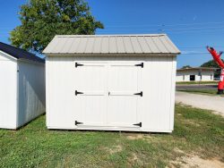 Two 10x12 Garden Sheds on sale in a grassy area near me.