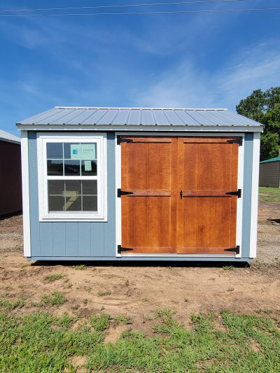 A 10x12 Utility Shed with a wooden door on sale.
