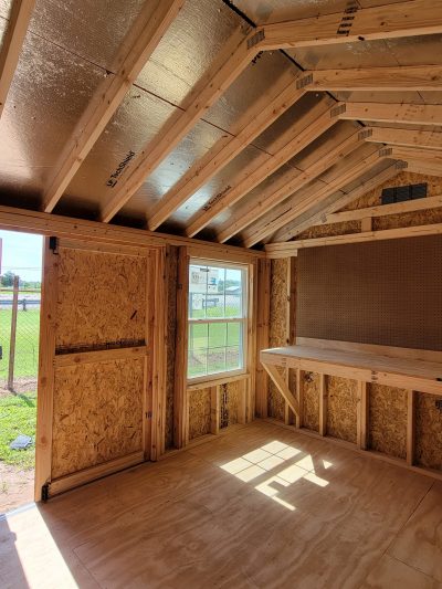 Explore a spacious 10x12 Utility Shed adorned with rustic wood beams and an elegant window for a glimpse of the outdoors. Whether you're searching for sheds for sale near me or seeking out the nearest shed store