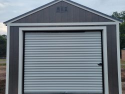 A white and gray 12x20 Garage Shed with a roll up door available for sale.