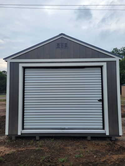A white and gray 12x20 Garage Shed with a roll up door available for sale.