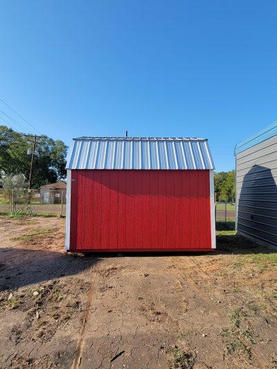 An 8x12 Lofted Barn Shed with a metal roof sitting on a dirt lot is available for sale.
