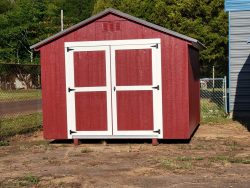 A red 10x12 Basic Shed with a white door available for sheds on sale.