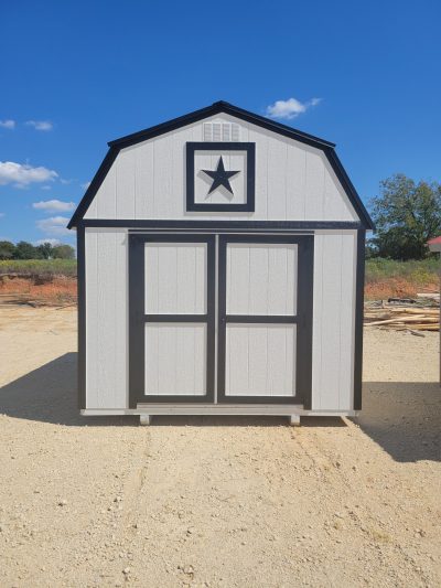 A white and black 10x12 Lofted Barn Shed with a star on it, available for sale.