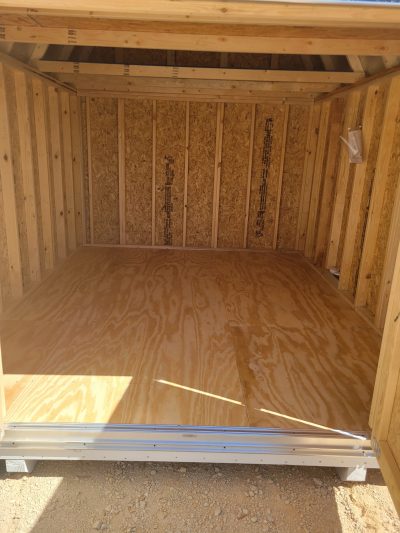 Experience the spacious interior of a 10x12 Lofted Barn Shed with durable wood flooring.