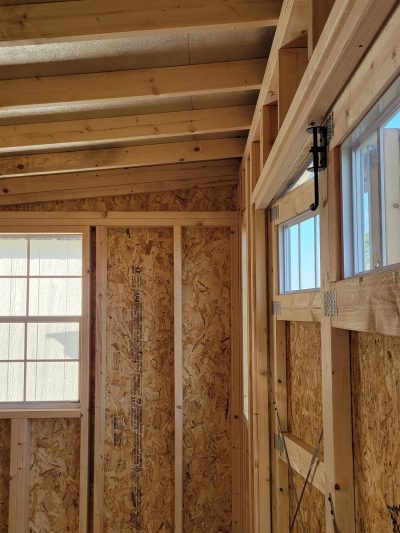 An 8x12 Studio Shed under construction with wood framing, available for sale near me.