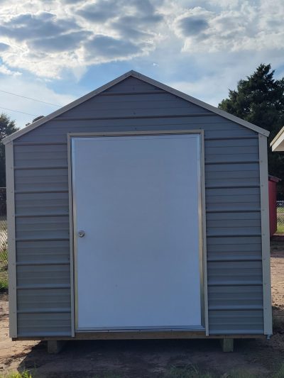 An 8x12 Metal Shed for sale with a door on it.