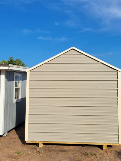 Two 8x12 Metal Sheds on a dirt lot available for sale.