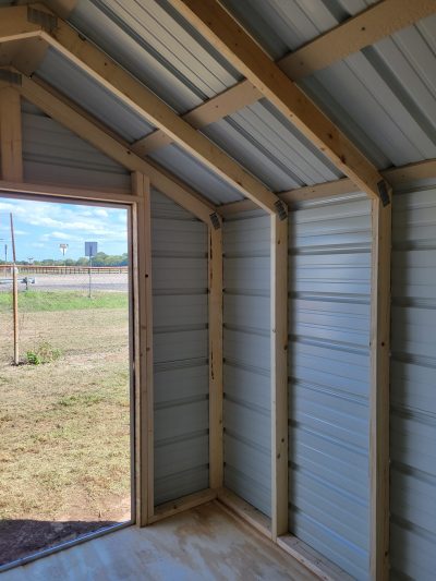 Explore a spacious 8x12 Metal Shed, featuring an inviting open door.