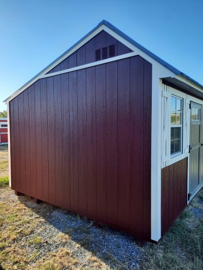 A 10x16 Garden Shed for sale in a field with red and white colors.