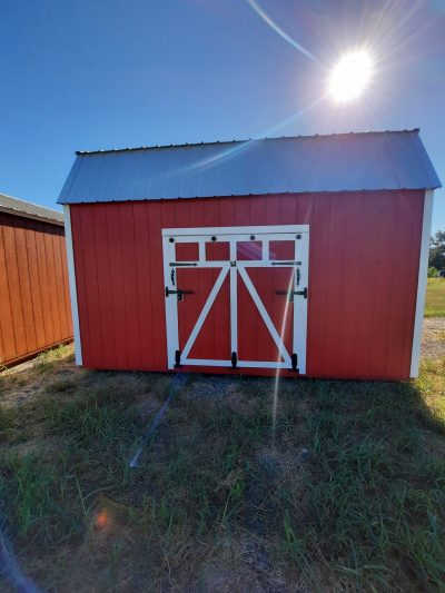 For sale: A 10x16 Lofted Barn Shed with a white door available at a shed store near me.