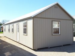 A 16x50 Chalet Shed in a parking lot.