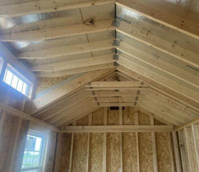 The room features a ceiling adorned with beautiful 10x20 Chalet Shed beams and rafters.