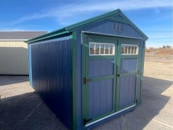 An 8x14 Utility Shed for sale in a dirt lot.