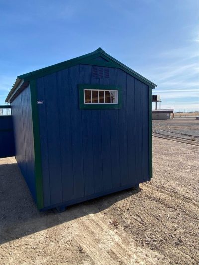 For sale 8x14 Utility Shed: A blue and green 8x14 Utility Shed sitting in a dirt lot.