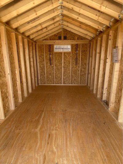 The inside of a 8x14 Utility Shed with wood flooring, available for sheds on sale near me.