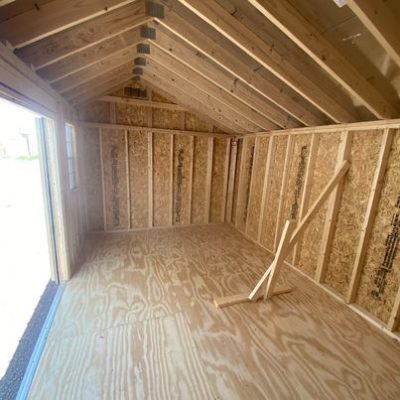 The inside of a 10x16 Garden Shed for sale near me with wood flooring.