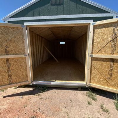 A 12x24 Utility Shed on sale with a door open.