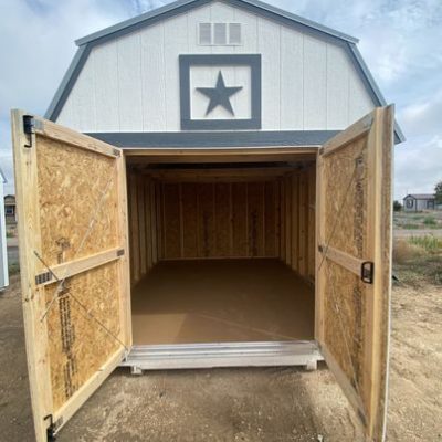 A white 10x12 Lofted Barn Shed with a star on the door, available for sale at the nearby shed store.