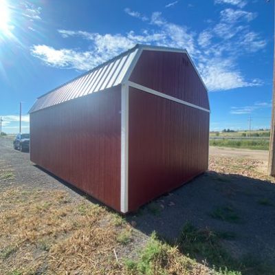 A 16x24 Lofted Barn Shed sitting on a dirt lot.