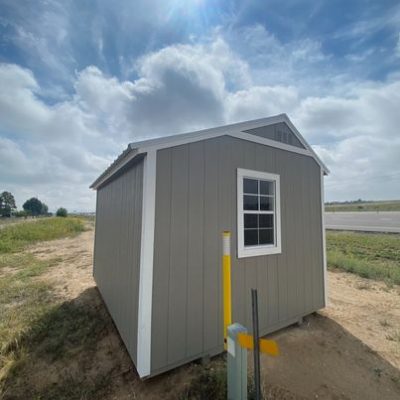 A 10x12 Garden Shed for sale in the middle of a field.