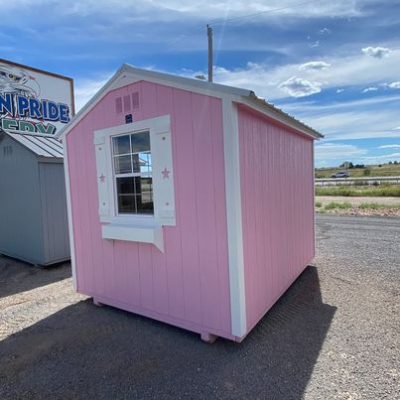 An 8x10 Utility Shed for sale, sitting on the side of the road.
