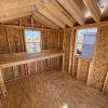 An 8x10 Utility Shed with windows and a desk, perfect for organizing and storing your belongings.