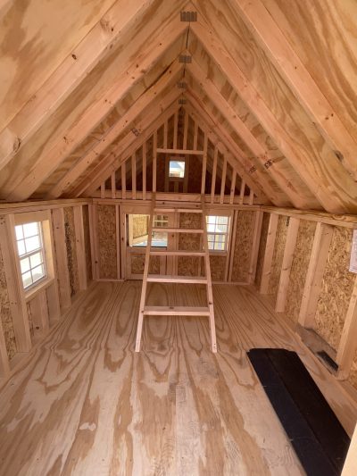 The inside of a 8x12 Hideout Playhouse Shed with wooden floors and a ladder. This cozy living space features stylish wooden floors and compact yet functional design. A ladder provides access to the lofted area, maximizing.