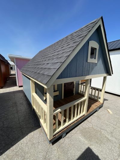 For sale: An 8x12 Hideout Playhouse Shed in a parking lot.