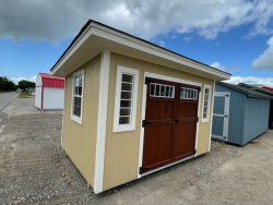 For sale: Two 8x12 Studio Sheds near me in a parking lot.