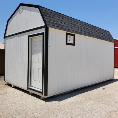 A white and black 12x20 Lofted Barn Shed with a black door available at a shed store near me.