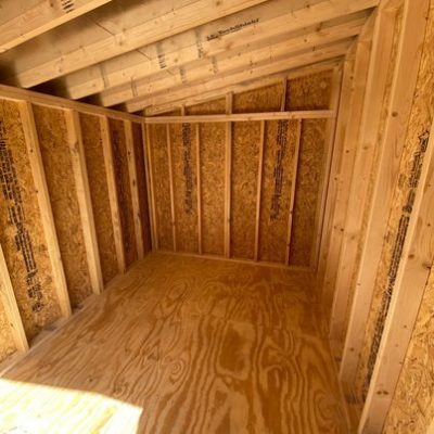The inside of a storage shed with wood flooring available for 8x12 Studio Sheds on sale near me.