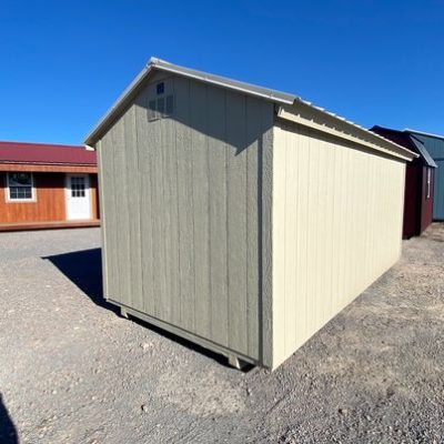 For sale: An 8x16 Basic Shed sitting in a gravel lot.