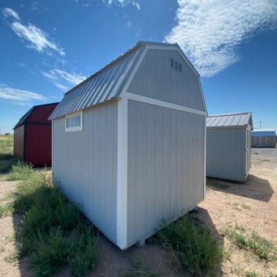 For sale: Two 8x12 Lofted Barn Sheds in the middle of a field.