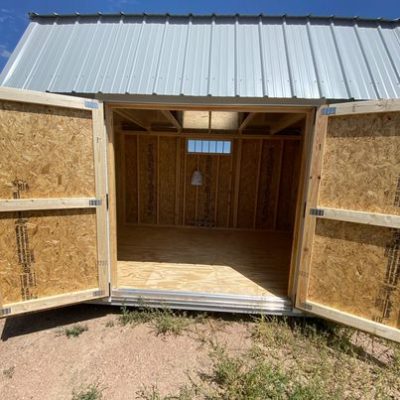 A small 8x12 Lofted Barn Shed for sale, with a door open.
