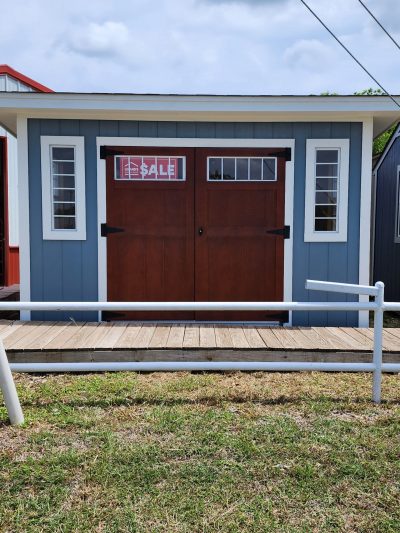 An 8x12 Studio Shed with a blue door is available for sale.
