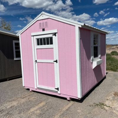 An 8x10 Utility Shed for sale, sitting in a parking lot.