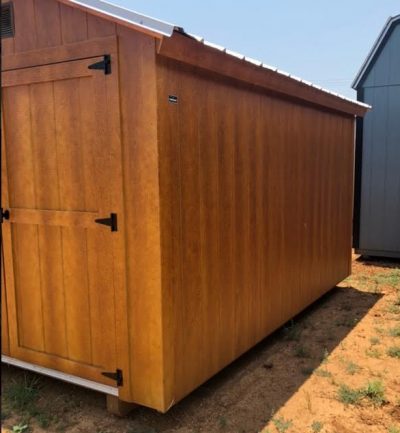 An 8x12 Basic Shed for sale in a dirt field.