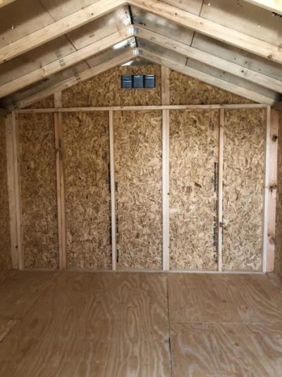 A 10x12 Basic Shed for sale near me, featuring plywood walls and a roof.