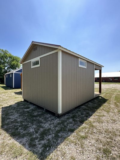 A 12x18 Cabinette Shed for sale sitting on a grassy field.