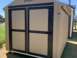An 8x12 Basic Shed in a field for sale.