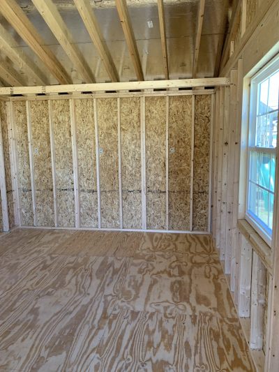 A for sale 12x24 Cottage Shed with plywood walls and wood flooring.