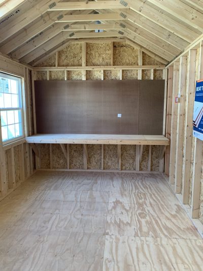A wood-floored 10x20 Chalet Shed with a desk.