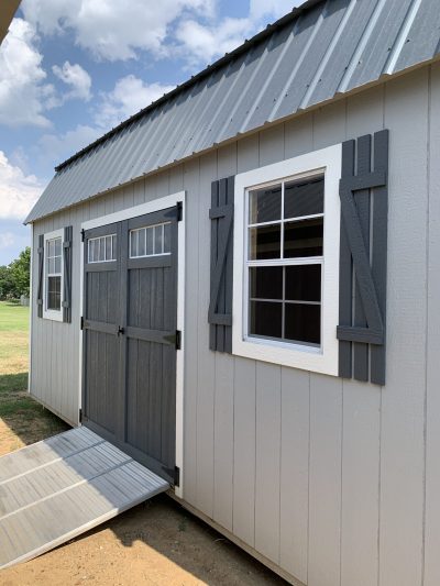 A gray 10x20 Lofted Barn shed with windows, available for sheds sale near me.